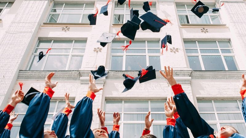 Graduates throwing caps in the air