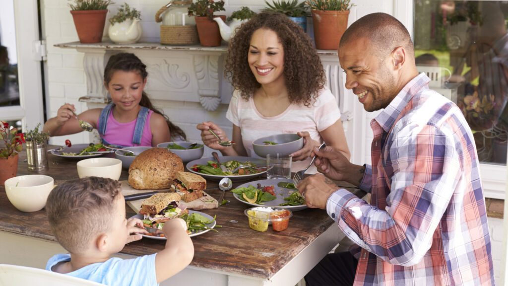 Family eating a meal outside.