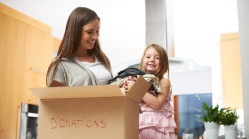 Mom and child making a donation box.